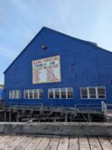 Blue Alaska fishing hub building on dock